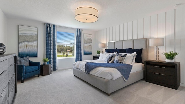 bedroom with light carpet and a textured ceiling