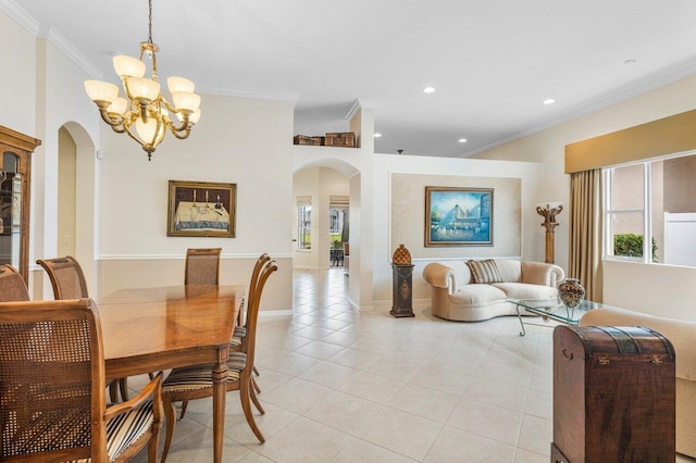 dining space with a chandelier, crown molding, and light tile patterned floors