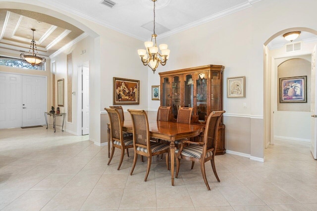 dining space with crown molding, a chandelier, light tile patterned floors, and a tray ceiling