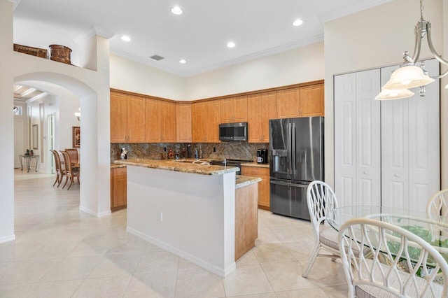 kitchen with a kitchen island, hanging light fixtures, stainless steel fridge with ice dispenser, light stone counters, and light tile patterned floors