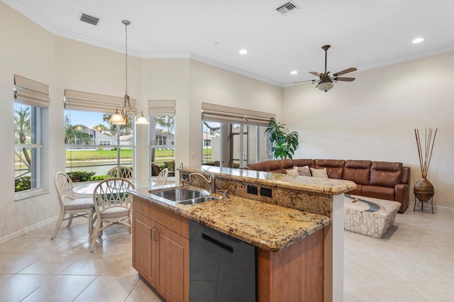 kitchen featuring dishwasher, sink, pendant lighting, an island with sink, and light stone counters