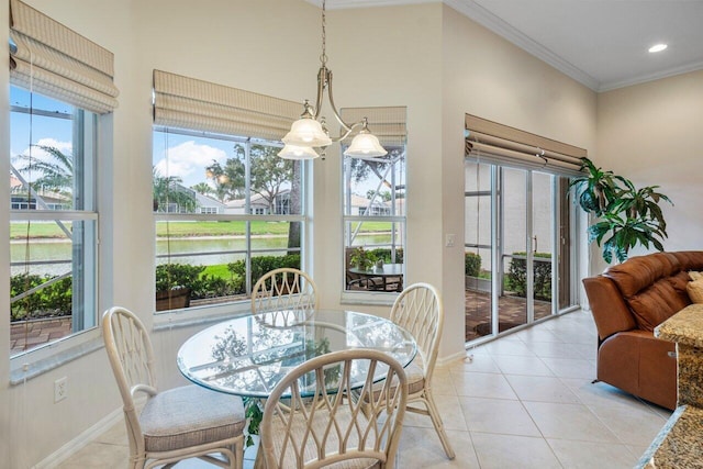 sunroom / solarium with a chandelier and a water view