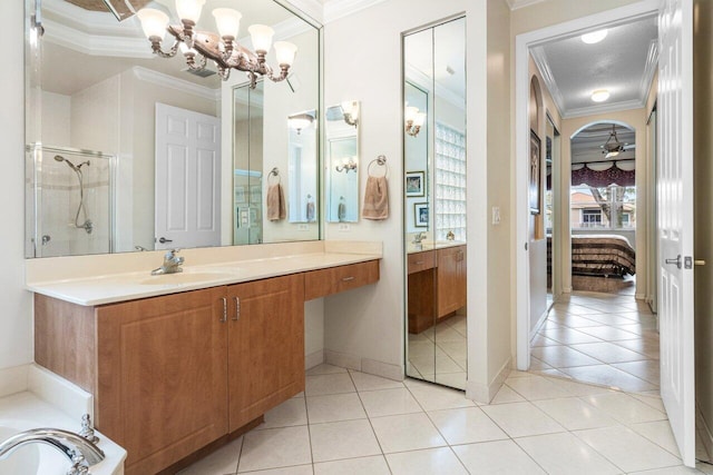 bathroom with tile patterned flooring, vanity, and ornamental molding