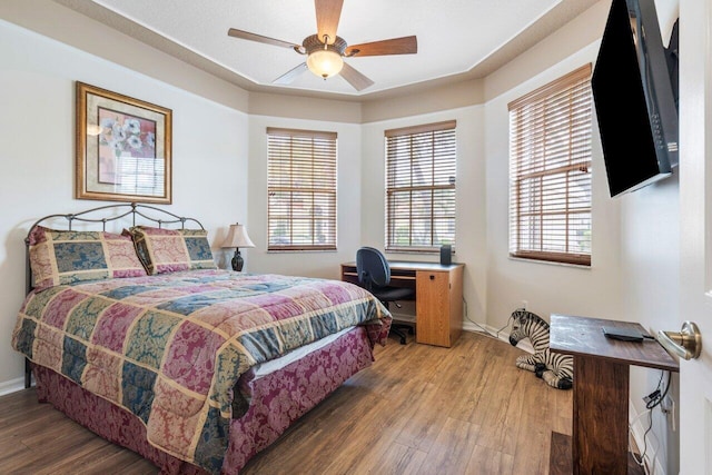 bedroom with ceiling fan and hardwood / wood-style floors