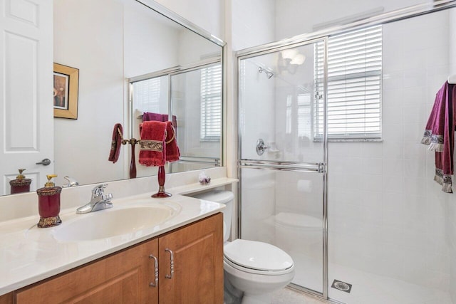 bathroom featuring toilet, walk in shower, and vanity