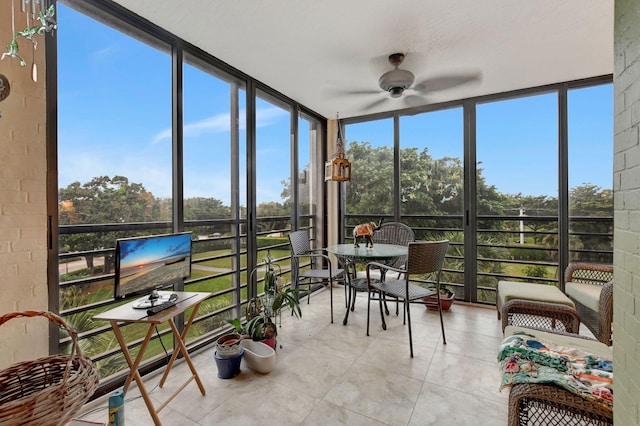 sunroom / solarium featuring ceiling fan