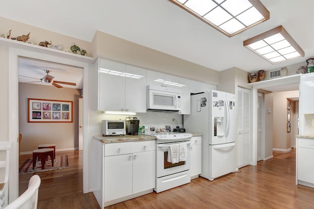 kitchen featuring ceiling fan, white cabinets, white appliances, light hardwood / wood-style floors, and backsplash