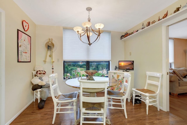 dining room with an inviting chandelier and wood-type flooring