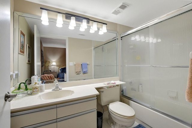 full bathroom featuring vanity, toilet, and combined bath / shower with glass door