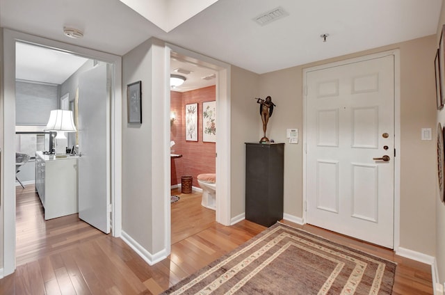 foyer entrance with hardwood / wood-style flooring