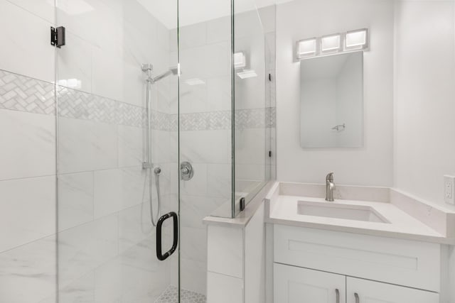 bathroom with an enclosed shower and vanity