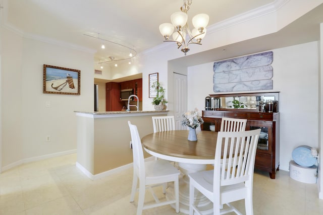 dining room featuring sink, crown molding, and a notable chandelier