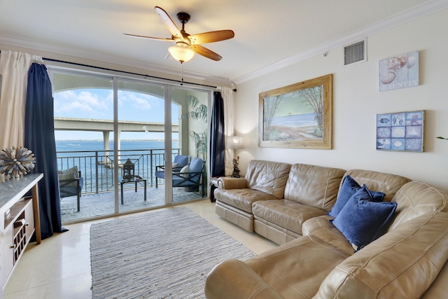 living room with ceiling fan, a water view, and crown molding