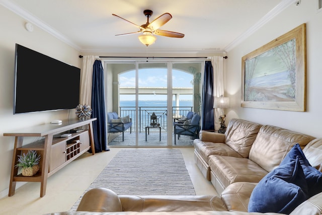 living room featuring ceiling fan, a water view, and ornamental molding