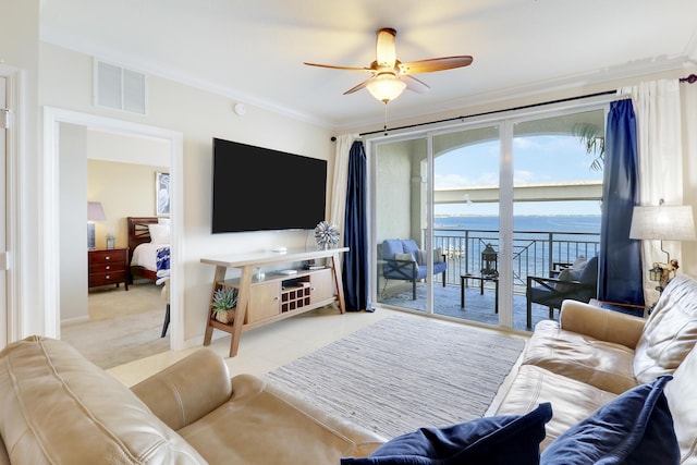 living room with ceiling fan and crown molding