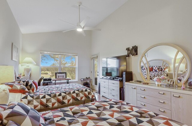 bedroom featuring ceiling fan and high vaulted ceiling