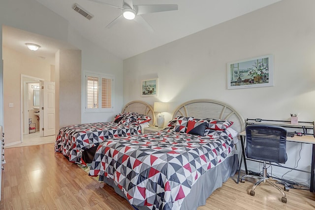 bedroom featuring light wood-type flooring, vaulted ceiling, and ceiling fan