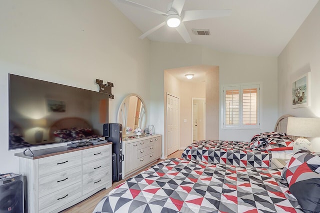 bedroom with ceiling fan, light hardwood / wood-style flooring, and vaulted ceiling