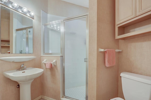 bathroom with toilet and an enclosed shower