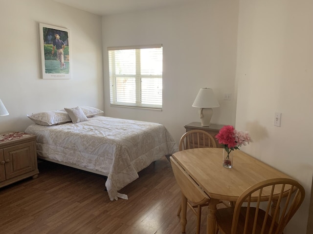 bedroom with dark wood-type flooring