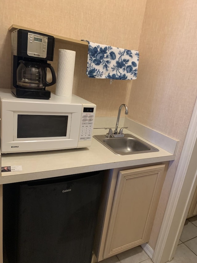 kitchen with sink and light tile patterned floors