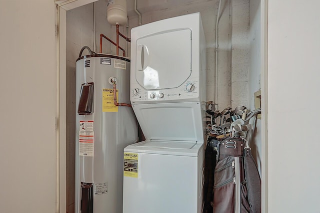 laundry area with water heater and stacked washer / drying machine