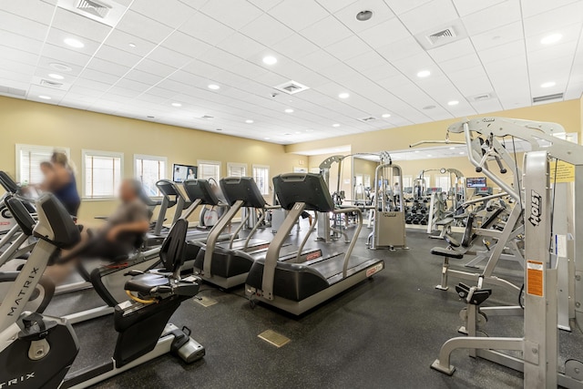 gym with a paneled ceiling