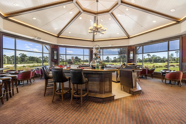 interior space featuring wooden ceiling, bar area, a healthy amount of sunlight, and an inviting chandelier