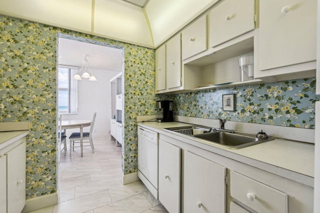 kitchen featuring a chandelier, dishwasher, sink, and white cabinets