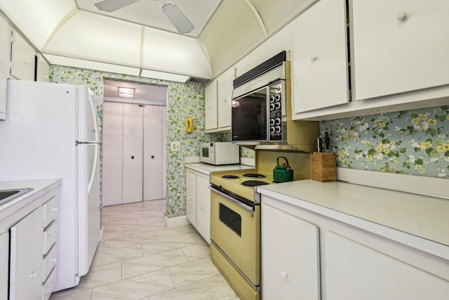 kitchen featuring ceiling fan, white appliances, and white cabinets