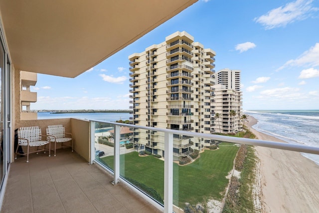 balcony featuring a beach view and a water view