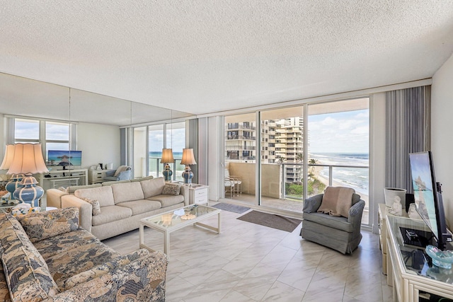 living room with floor to ceiling windows and a textured ceiling