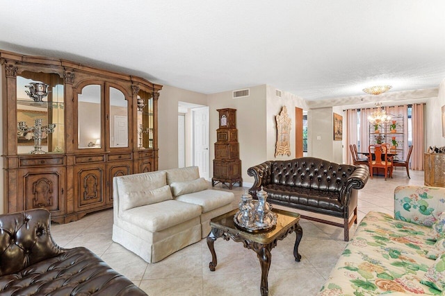 tiled living room with a chandelier and a textured ceiling