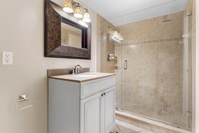 bathroom featuring vanity and a shower with shower door