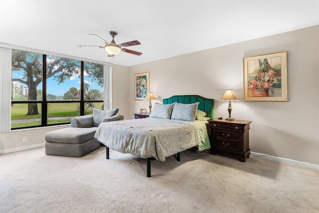 carpeted bedroom with baseboards and a ceiling fan