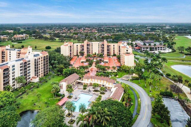 drone / aerial view featuring view of golf course and a water view