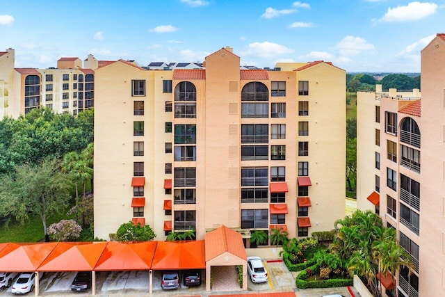 view of building exterior featuring uncovered parking