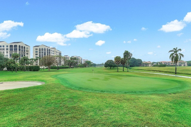 view of community featuring a lawn and golf course view
