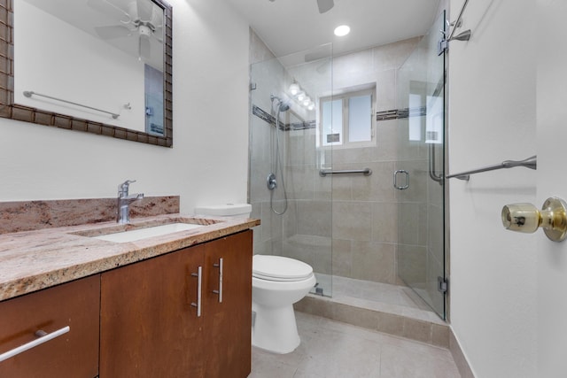 bathroom with walk in shower, vanity, ceiling fan, and toilet