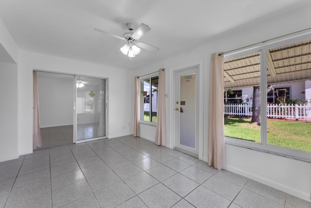 empty room with light tile patterned flooring and ceiling fan