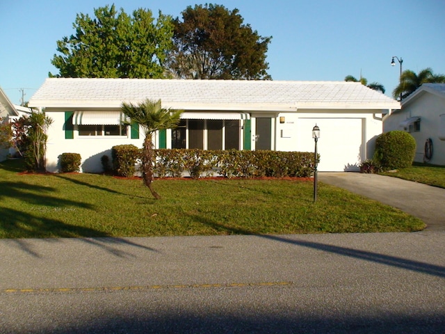 ranch-style home with a garage and a front yard