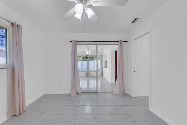 empty room featuring light tile patterned flooring and ceiling fan