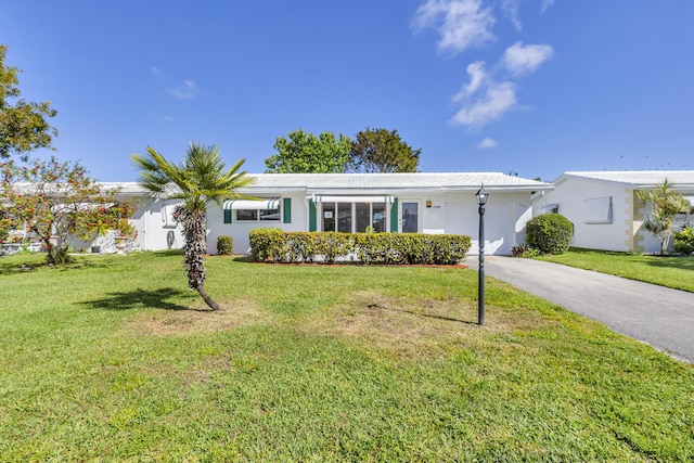 ranch-style home with a garage and a front yard