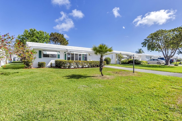 ranch-style home with a front lawn