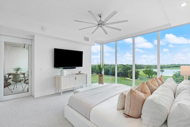 carpeted bedroom featuring access to exterior, visible vents, multiple windows, and ceiling fan