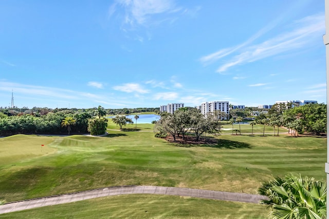 view of home's community with a water view, a view of city, golf course view, and a lawn