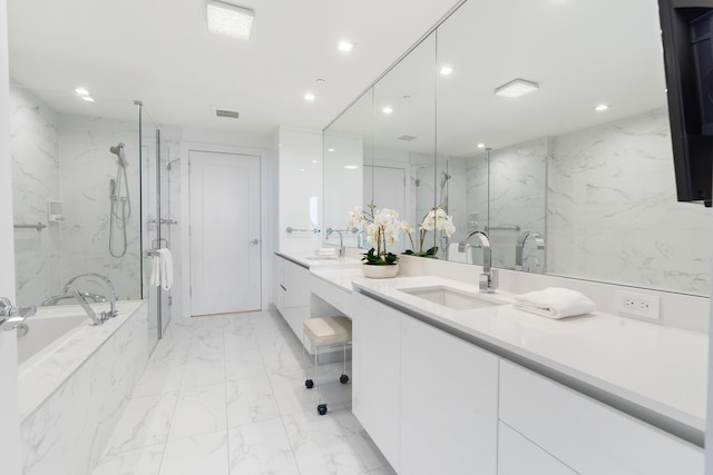 bathroom featuring marble finish floor, a sink, a marble finish shower, and recessed lighting