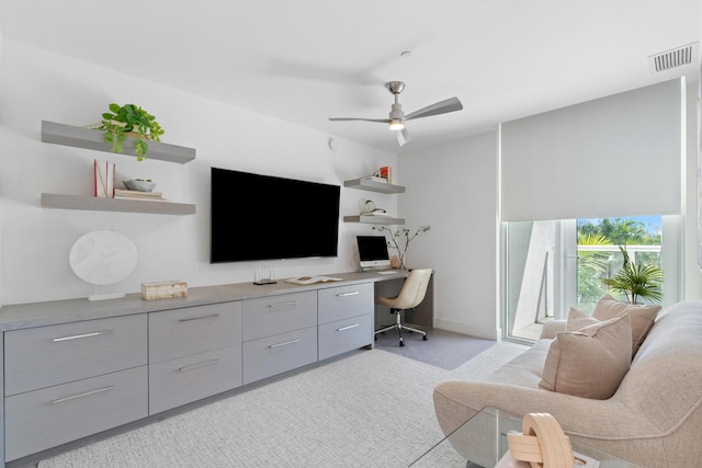 interior space with light carpet, baseboards, visible vents, and a ceiling fan