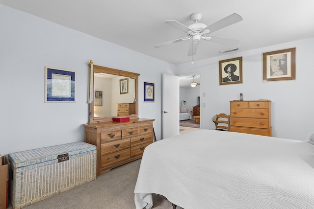 bedroom featuring ceiling fan and light carpet