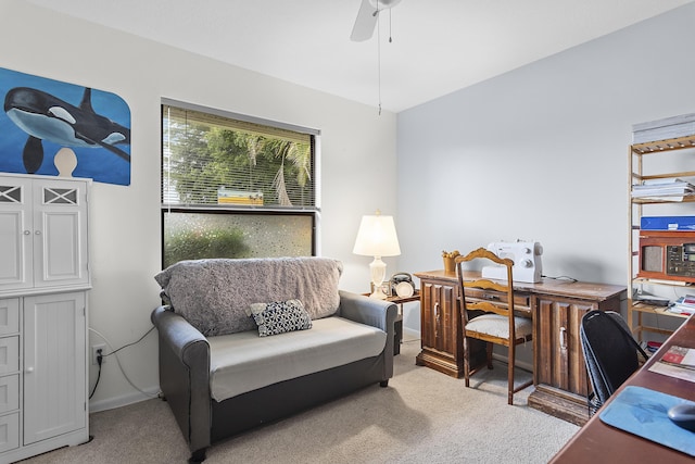 carpeted home office featuring ceiling fan